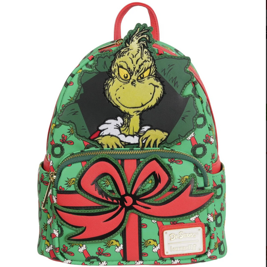 Backpack with Grinch design featuring a large red bow on a white background