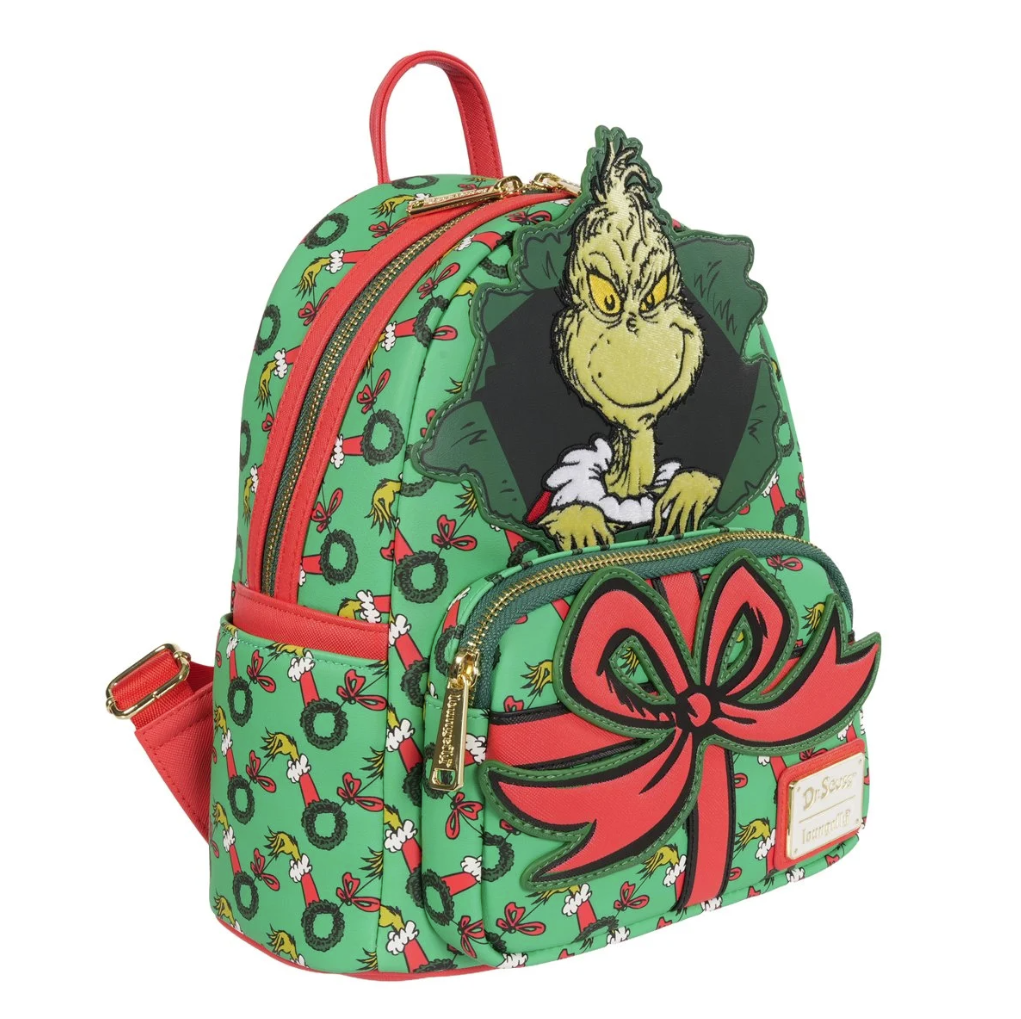 Backpack with Grinch design featuring a large red bow and green pattern on a white background