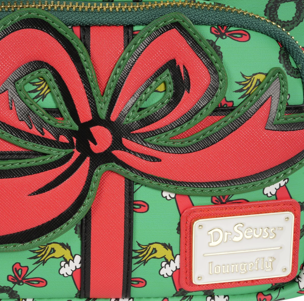 Close-up of a green bag with a red bow and Dr. Seuss branding.